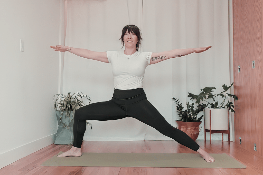 Student practicing Warrior II pose in a Level 1 Iyengar Yoga clas
